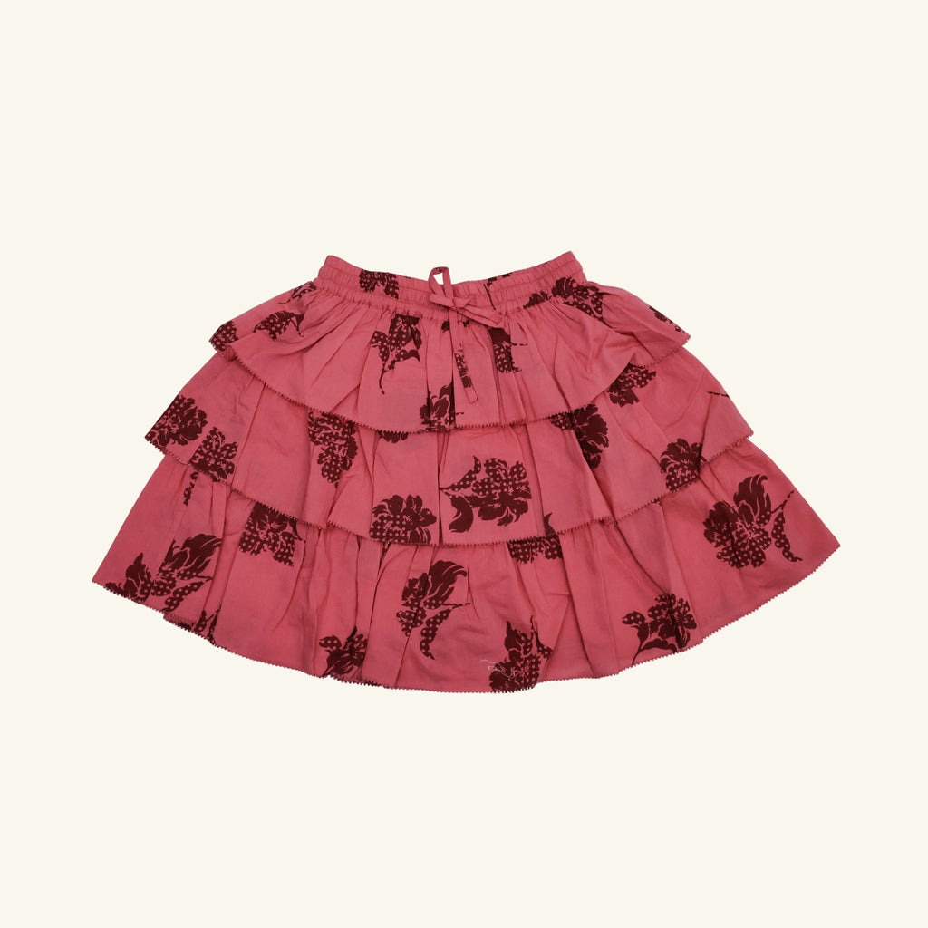 Red skirt with black floral patterns on a white background