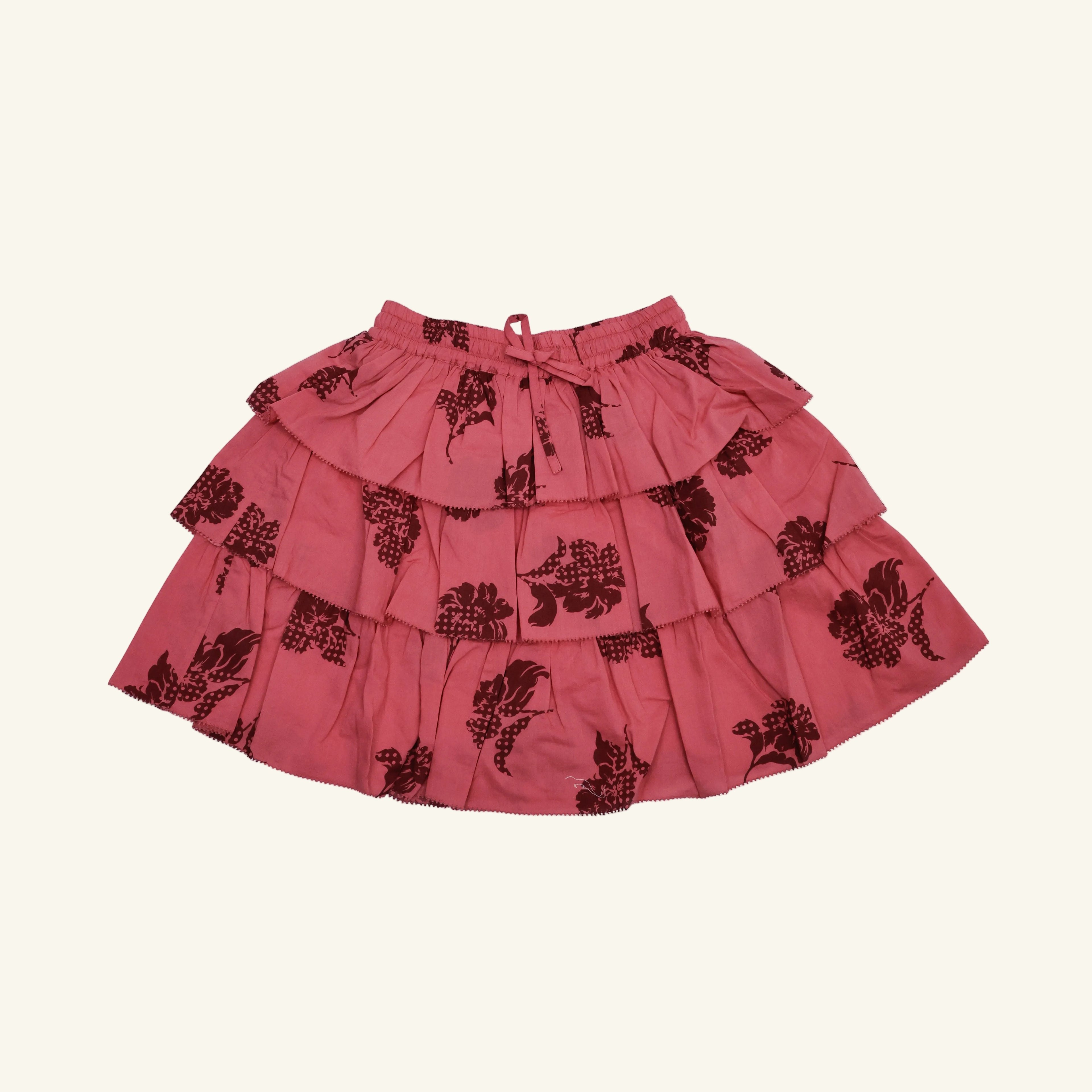 Red skirt with black floral patterns on a white background